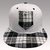 BLACK AND WHITE CHECKERED SNAP-BACK CAP