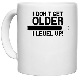                       UDNAG White Ceramic Coffee / Tea Mug 'Older | I DON'T GET OLDER I LEVEL UP!' Perfect for Gifting [330ml]                                              