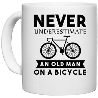                       UDNAG White Ceramic Coffee / Tea Mug 'Cycling | Never Underestimate' Perfect for Gifting [330ml]                                              