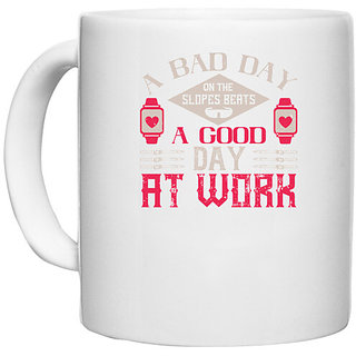                       UDNAG White Ceramic Coffee / Tea Mug 'Skiing | A bad day on the slopes a good day at work' Perfect for Gifting [330ml]                                              