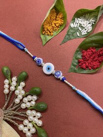 Fancy Designer Rakhi With White Evil Eye And Blue Beads Multicolor Thread Rakhi For Brother