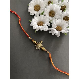                       Gold Plated Tortoise Designer Rakhi Bracelet With Multicolor Thread For Raksha Bandhan                                              
