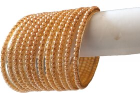 Handmade bangles and bracelets with golden color. Glass material.